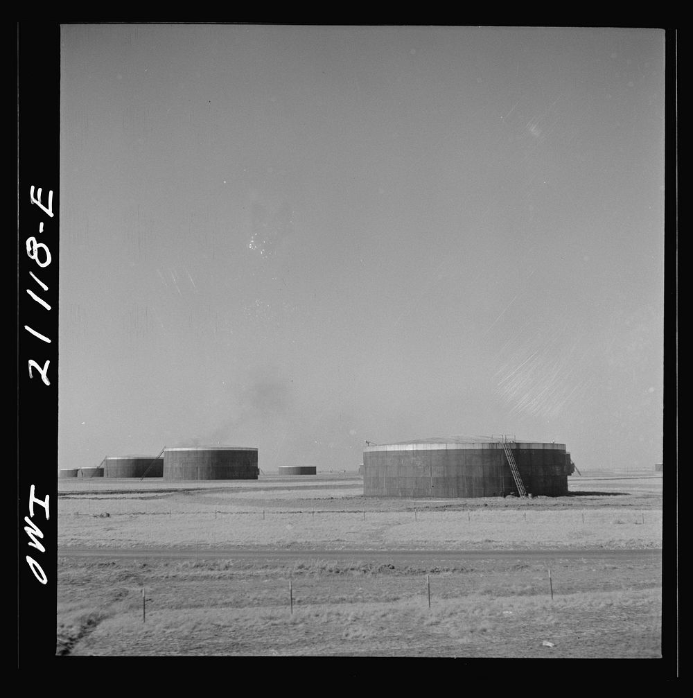 [Untitled photo, possibly related to: Pampa (vicinity), Texas. An oil storage tank along the Atchison, Topeka and Santa Fe…