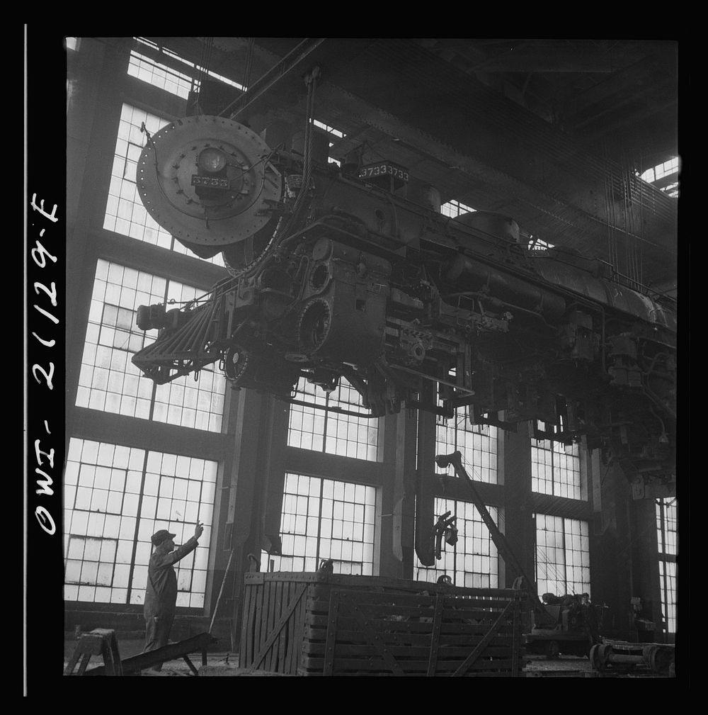 [Untitled photo, possibly related to: Albuquerque, New Mexico. Lifting an engine to be carried to another part of the…