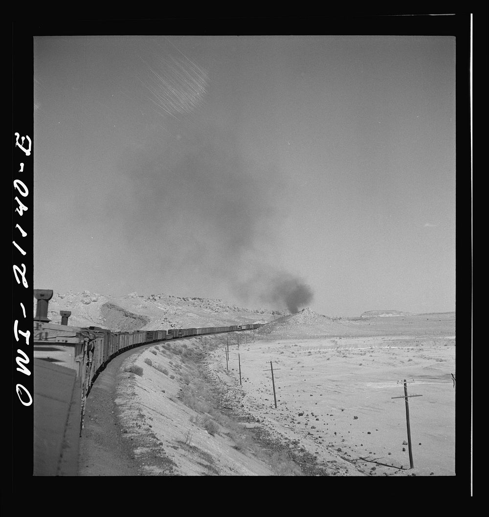 Quirk (vicinity), New Mexico. A train rounding a curve along the Atchison, Topeka and Santa Fe Railroad between Belen and…