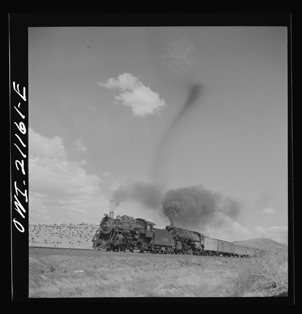 Acomita, New Mexico. A double-header passenger train passing on the Atchison, Topeka and Santa Fe Railroad between Belen and…