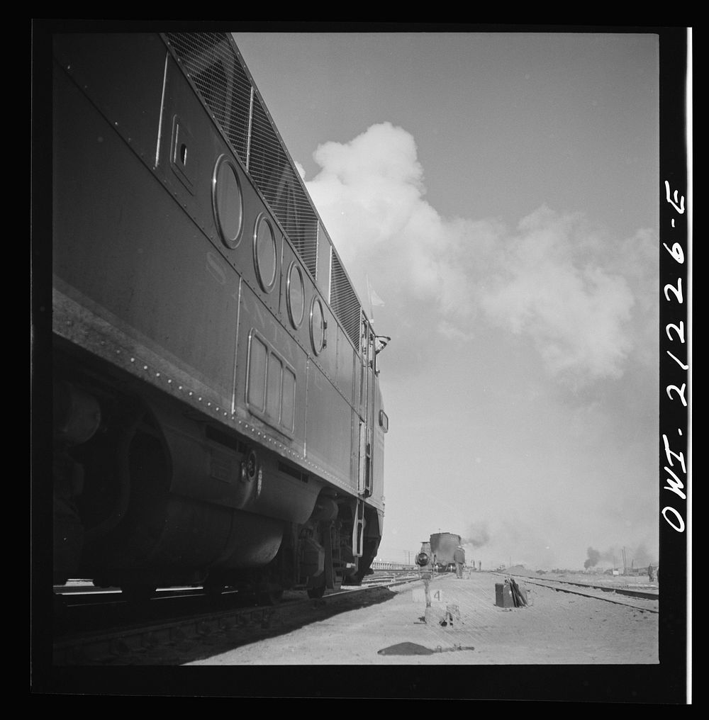 Winslow, Arizona. A diesel freight engine waiting to pull out of the Atchison, Topeka and Santa Fe Railroad yard. Sourced…