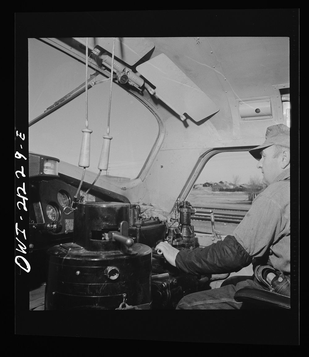 [Untitled photo, possibly related to: Winslow, Arizona. Engineer George Bertino in the cab of his diesel freight engine…