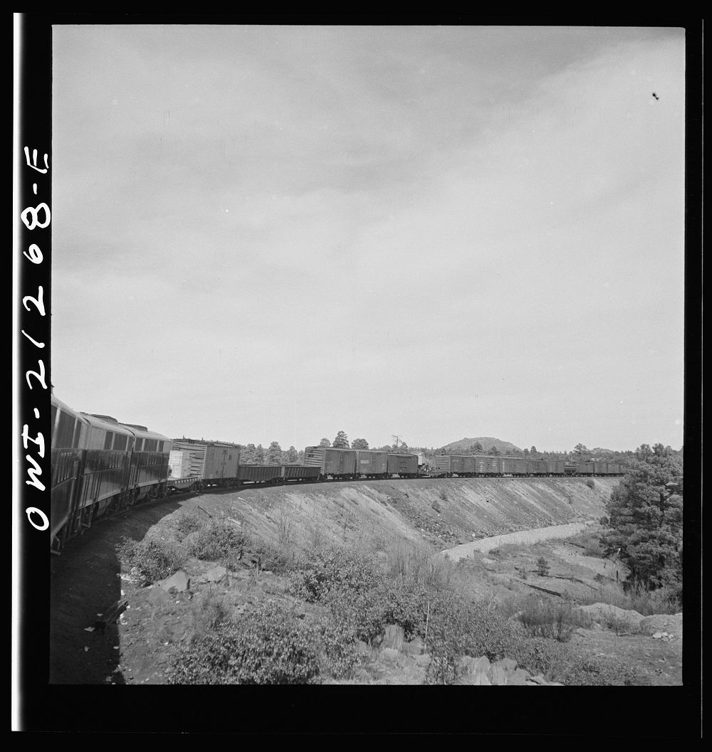 [Untitled photo, possibly related to: Williams, Arizona. A diesel freight train climbing through mountainous area along the…