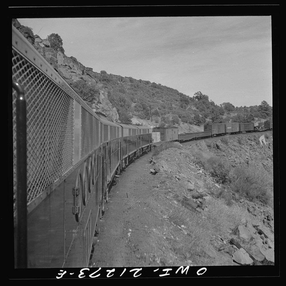 [Untitled photo, possibly related to: Williams, Arizona. A diesel freight train climbing through mountainous area along the…
