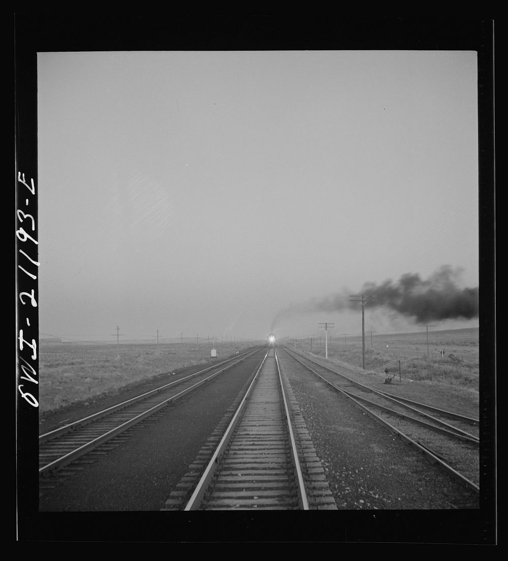 [Untitled photo, possibly related to: Gallup, New Mexico. A train on the Atchison, Topeka and Santa Fe Railroad between…