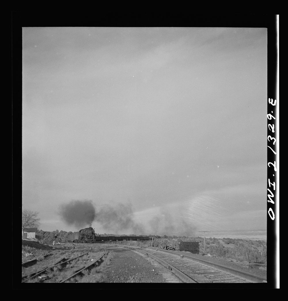 [Untitled photo, possibly related to: Gleed (vicinity), Arizona. A freight train going around a curve on the Atchison…