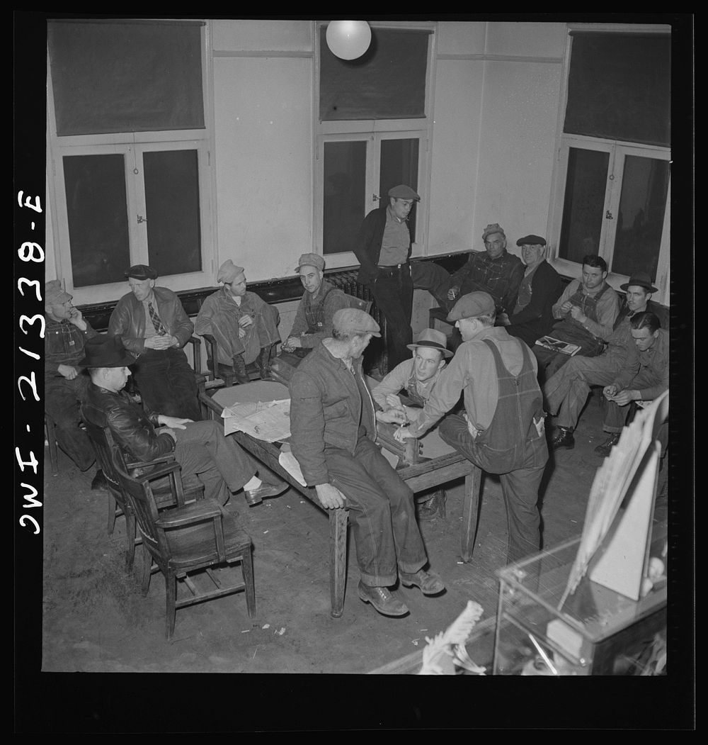 [Untitled photo, possibly related to: Seligman, Arizona. Railroad men lounging in the lobby of the Harvey House near the…