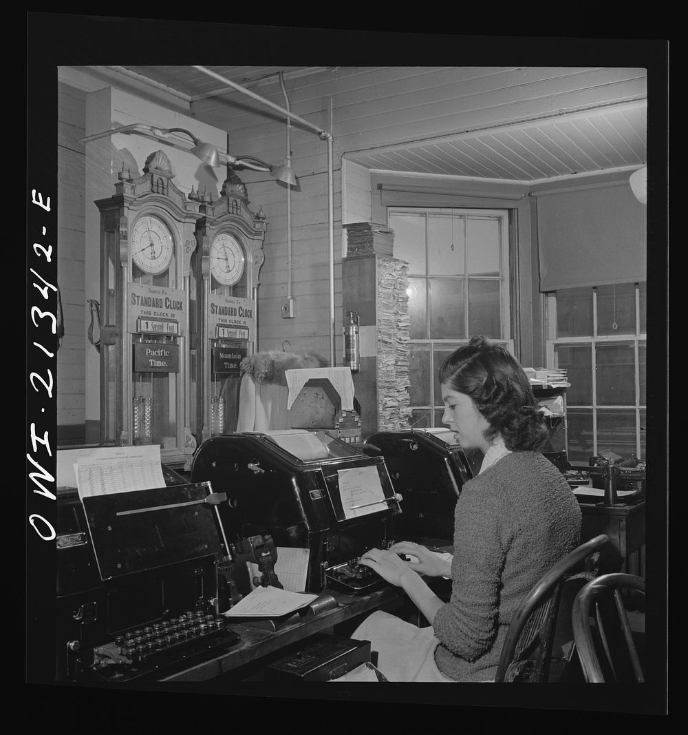 Seligman, Arizona. Teletype operator in the telegraph office of the Atchison, Topeka, and Santa Fe Railroad. The time here…