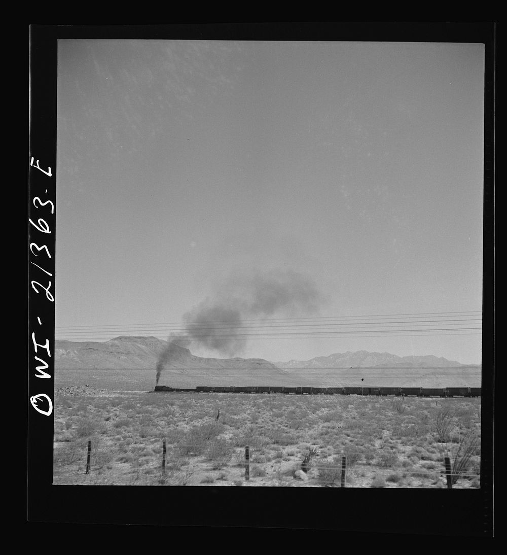 [Untitled photo, possibly related to: Kingman (vicinity), Arizona. A train on the Atchison, Topeka and Santa Fe Railroad…