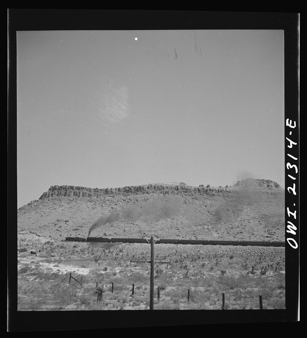 Kingman (vicinity), Arizona. A double-header eastbound passenger train on the Atchison, Topeka and Santa Fe Railroad between…