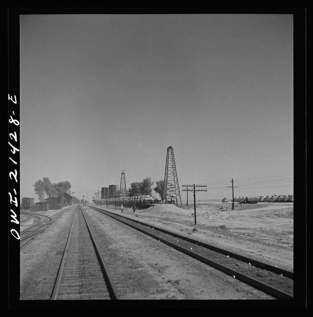 Goffs, California. Military tanks from a nearby army camp, loaded on flat cars along the Atchison, Topeka, and Santa Fe…