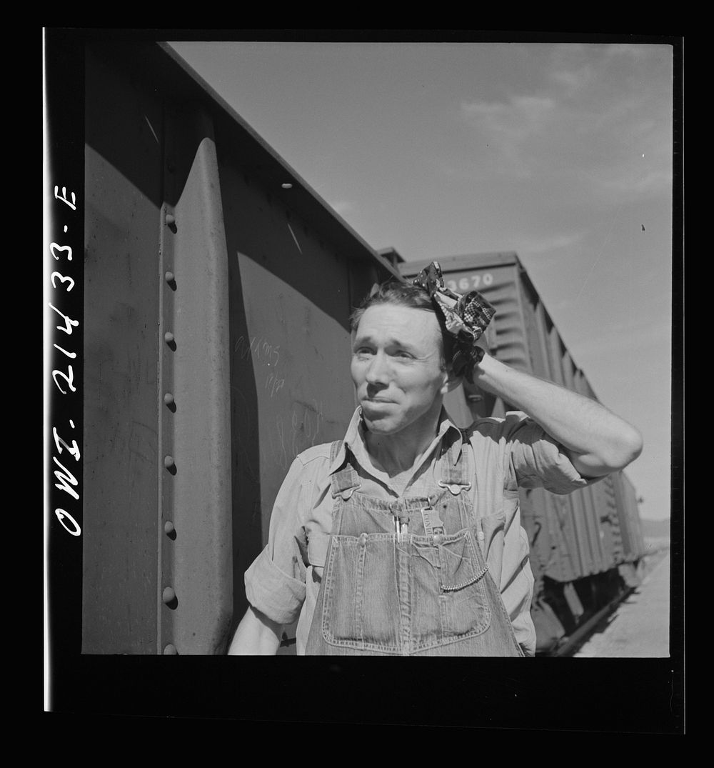 Ludlow, California. Conductor W.C. Scott in the Atchison, Topeka, and Santa Fe Railroad yards. His home is in Needles…