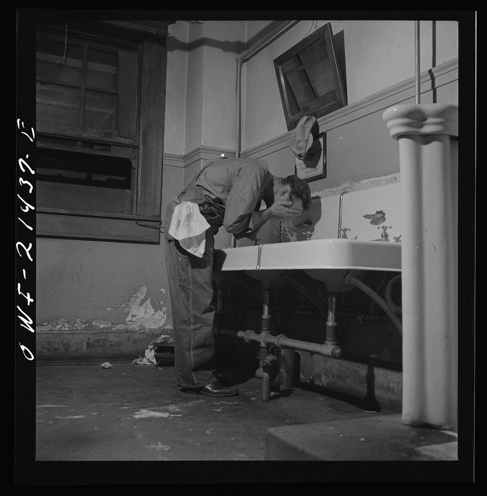 Barstow, California. Railroad worker washing up in the wash room of the reading room in the Atchison, Topeka, and Santa Fe…