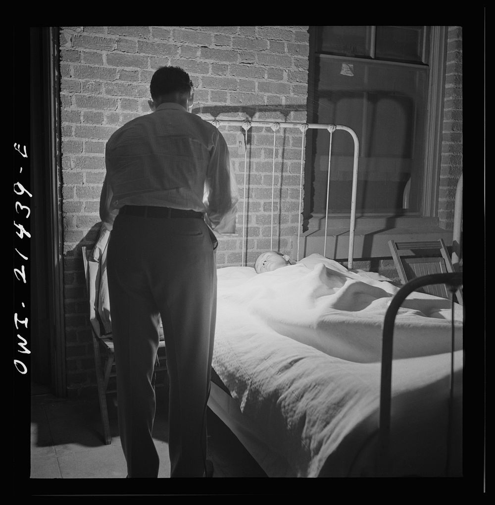 Barstow, California. Brakeman, Charles M. Dawes, being wakened to go to work by the caller at the reading room in the…