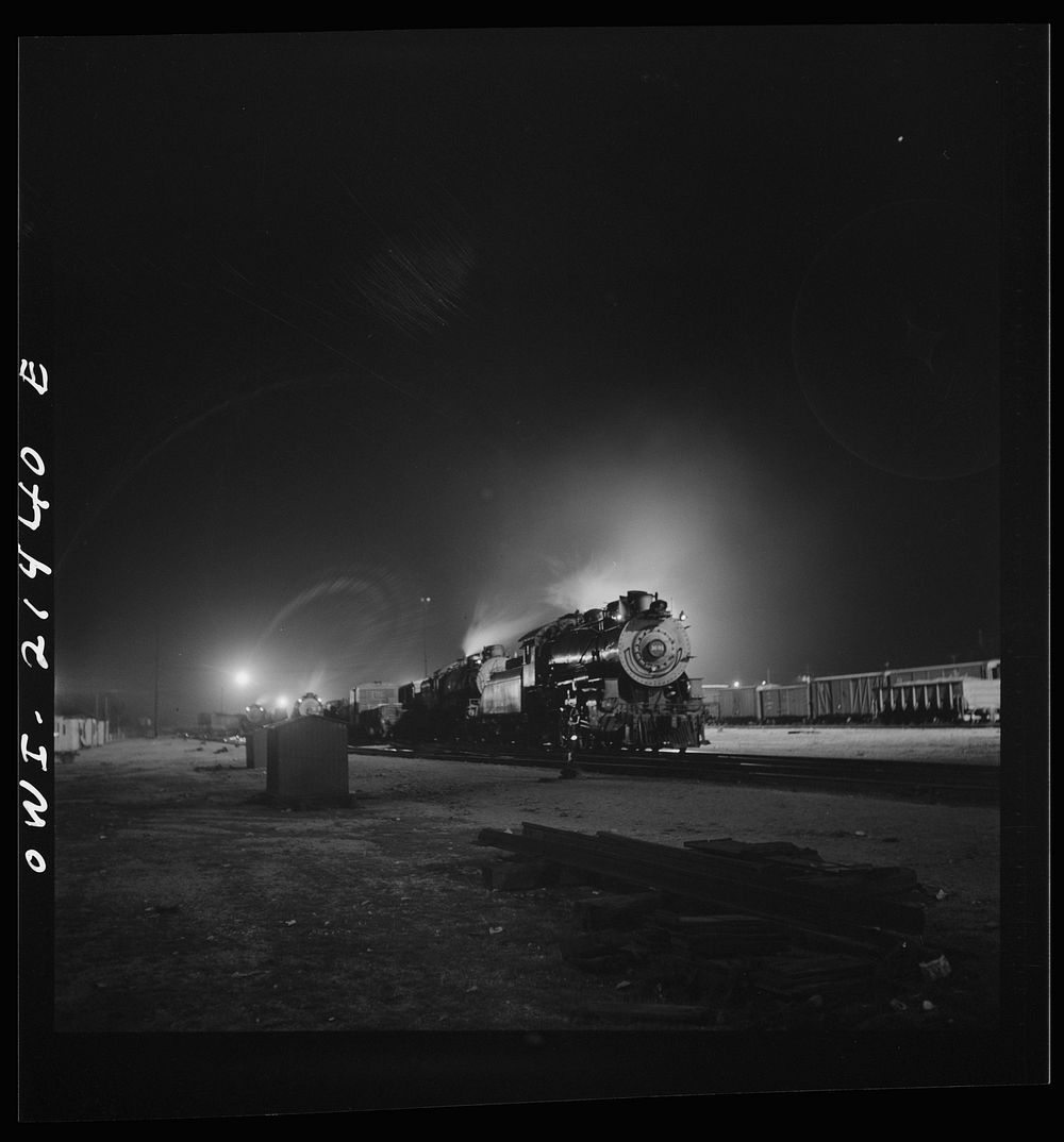 Barstow, California. A view of the Atchison, Topeka and Santa Fe Railroad yard at night. Sourced from the Library of…