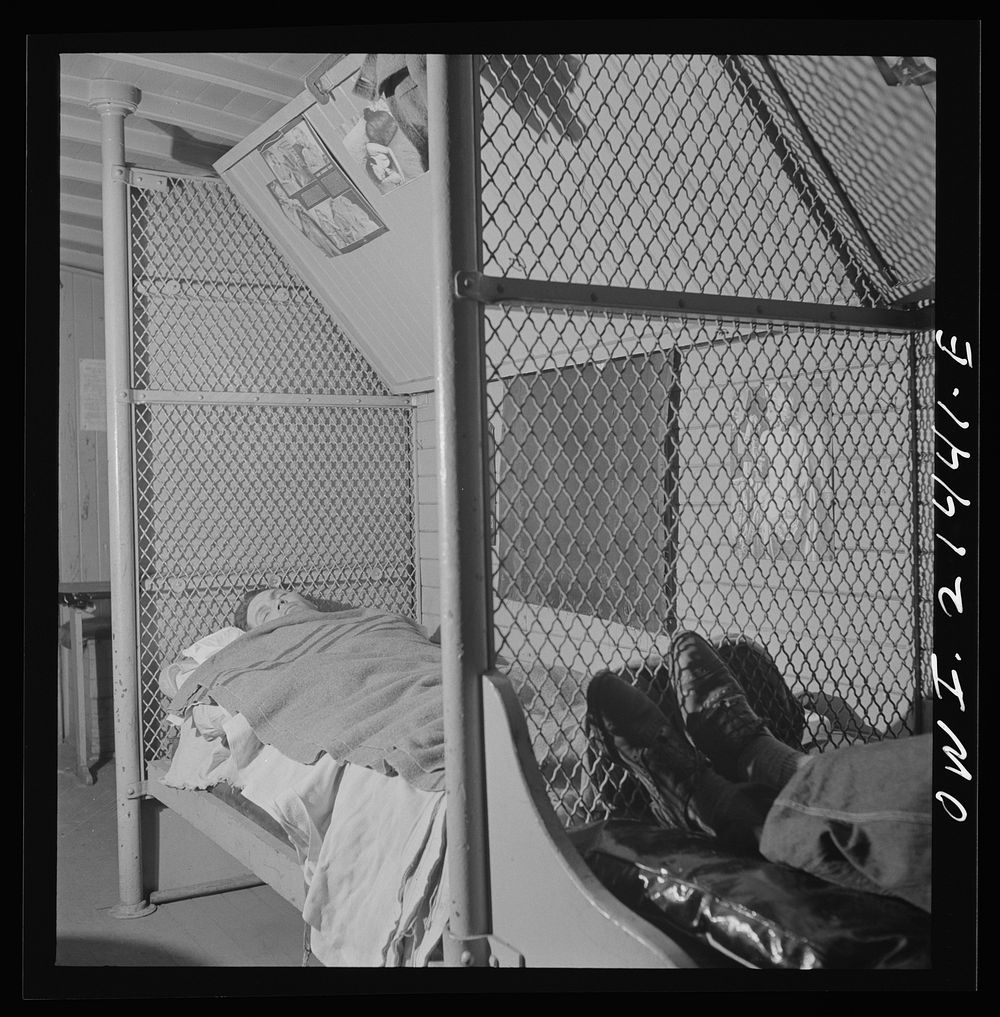 Barstow, California. Conductor, David L. Webb sleeping in his caboose. He works on the Atchison, Topeka and Santa Fe…