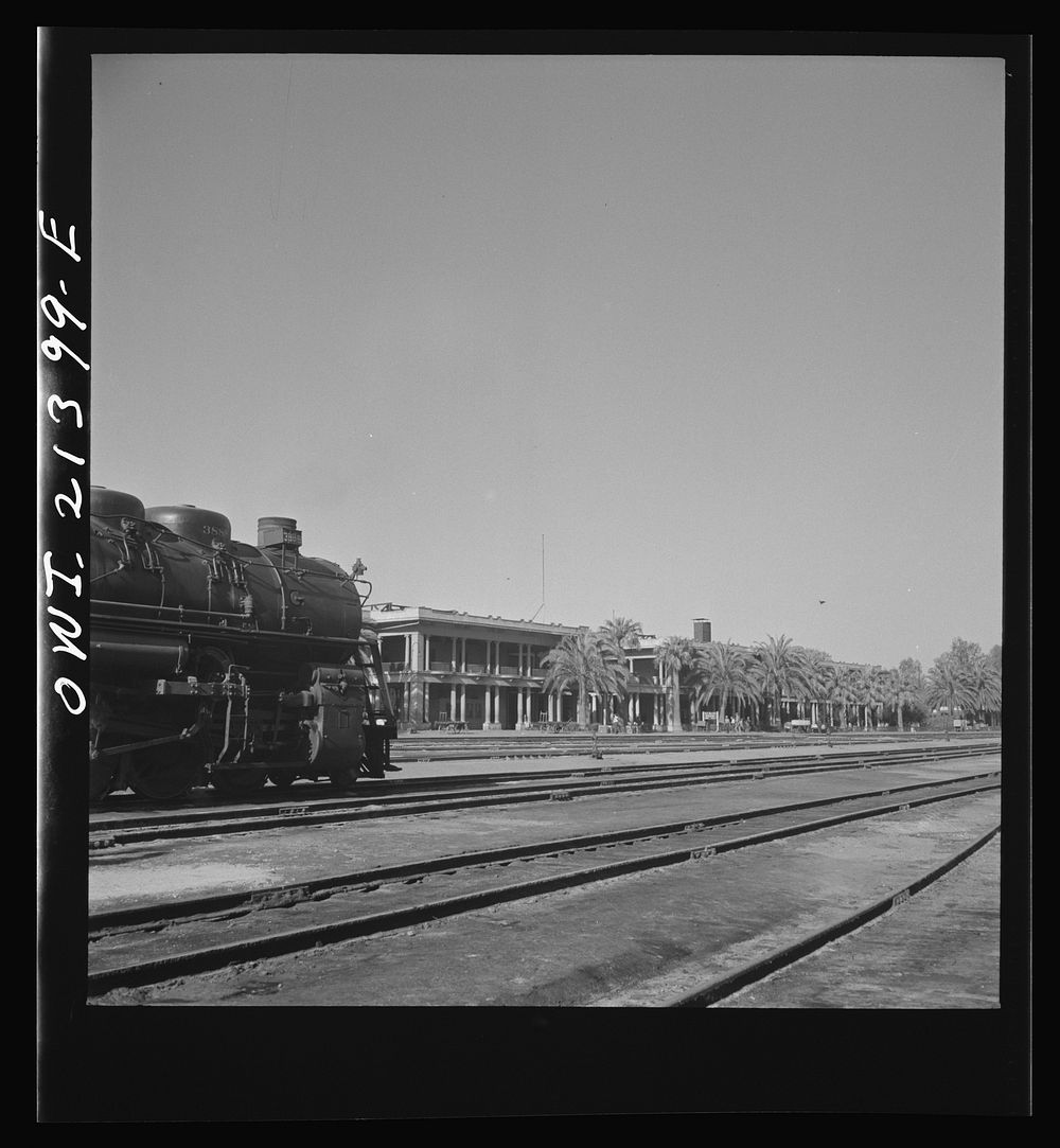[Untitled photo, possibly related to: Needles, California. A general view showing Harvey House and the depot in the…