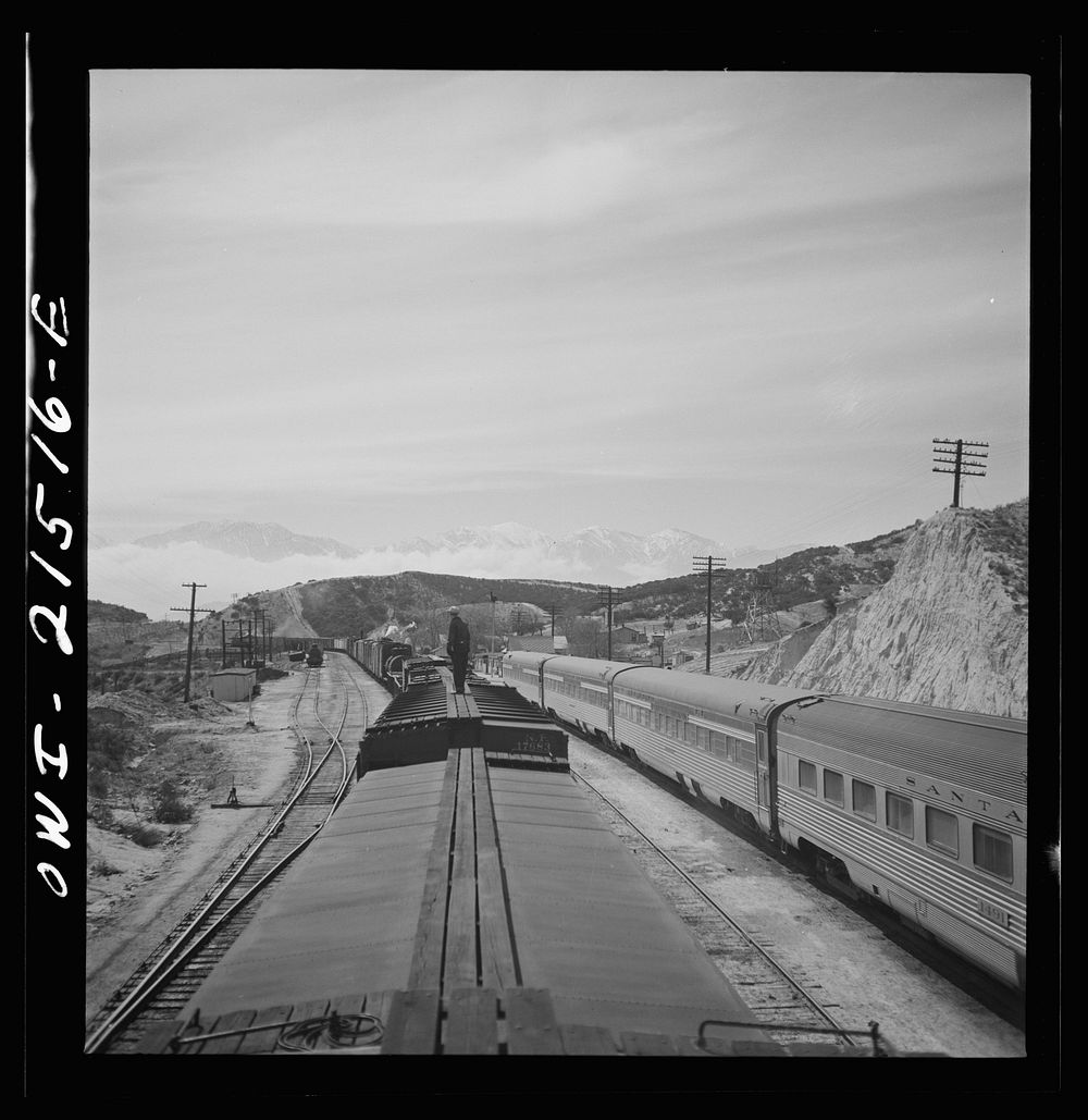 [Untitled photo, possibly related to: Summit (vicinity), California. Passing an eastbound passenger train, the Chief, while…