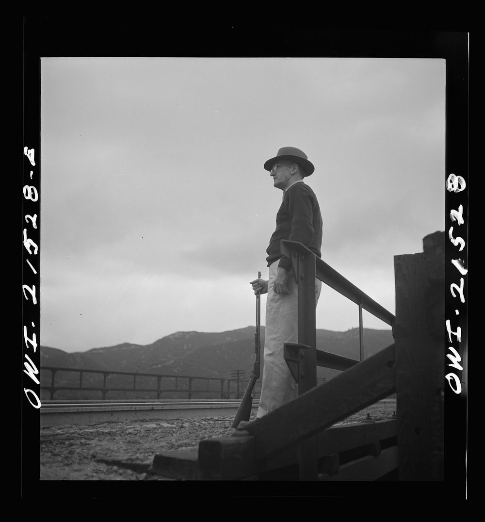Devore, California (near San Bernardino). Guard at a bridge along the Atchison, Topeka, and Santa Fe Railroad, between…