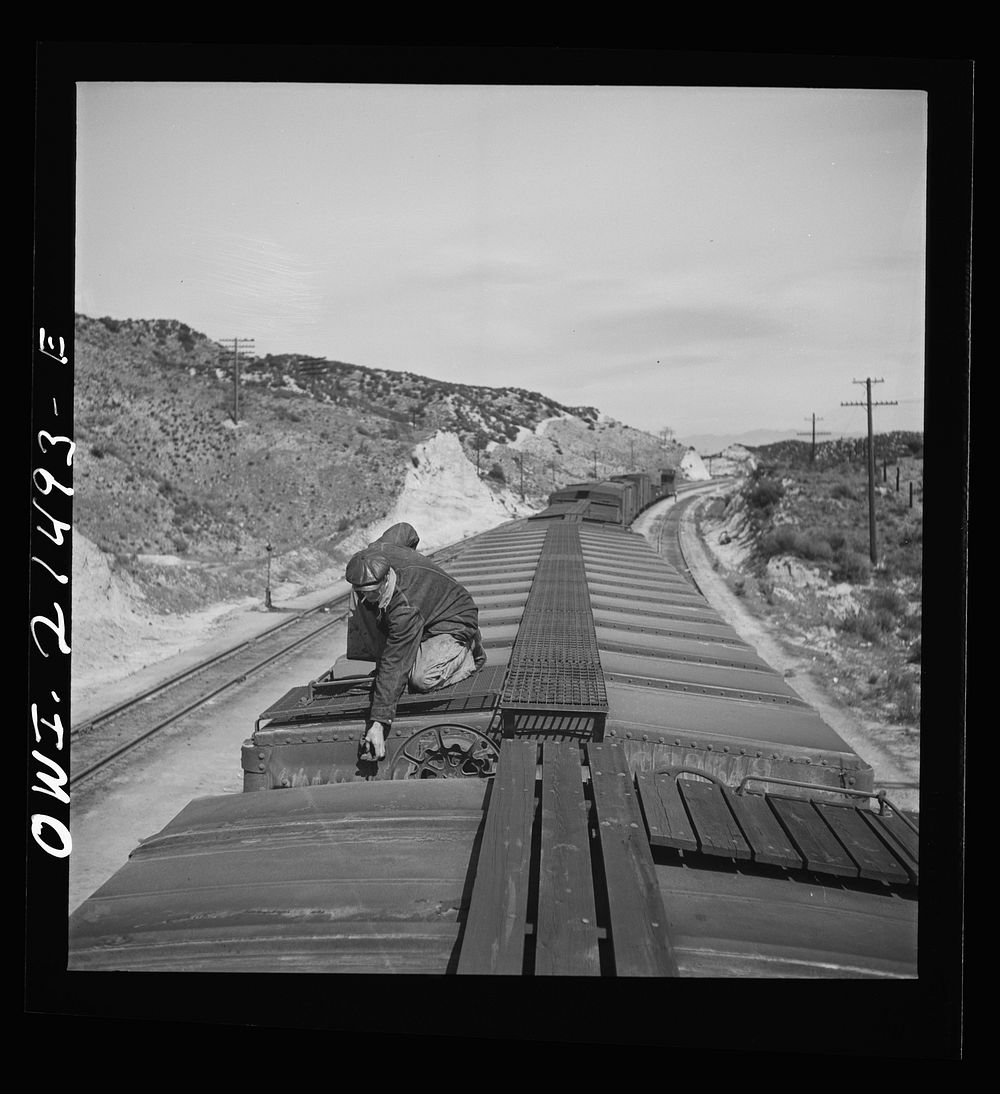 Summit, California. The brakeman opening the retainer valve on a car on the Atchison, Topeka and Santa Fe Railroad between…