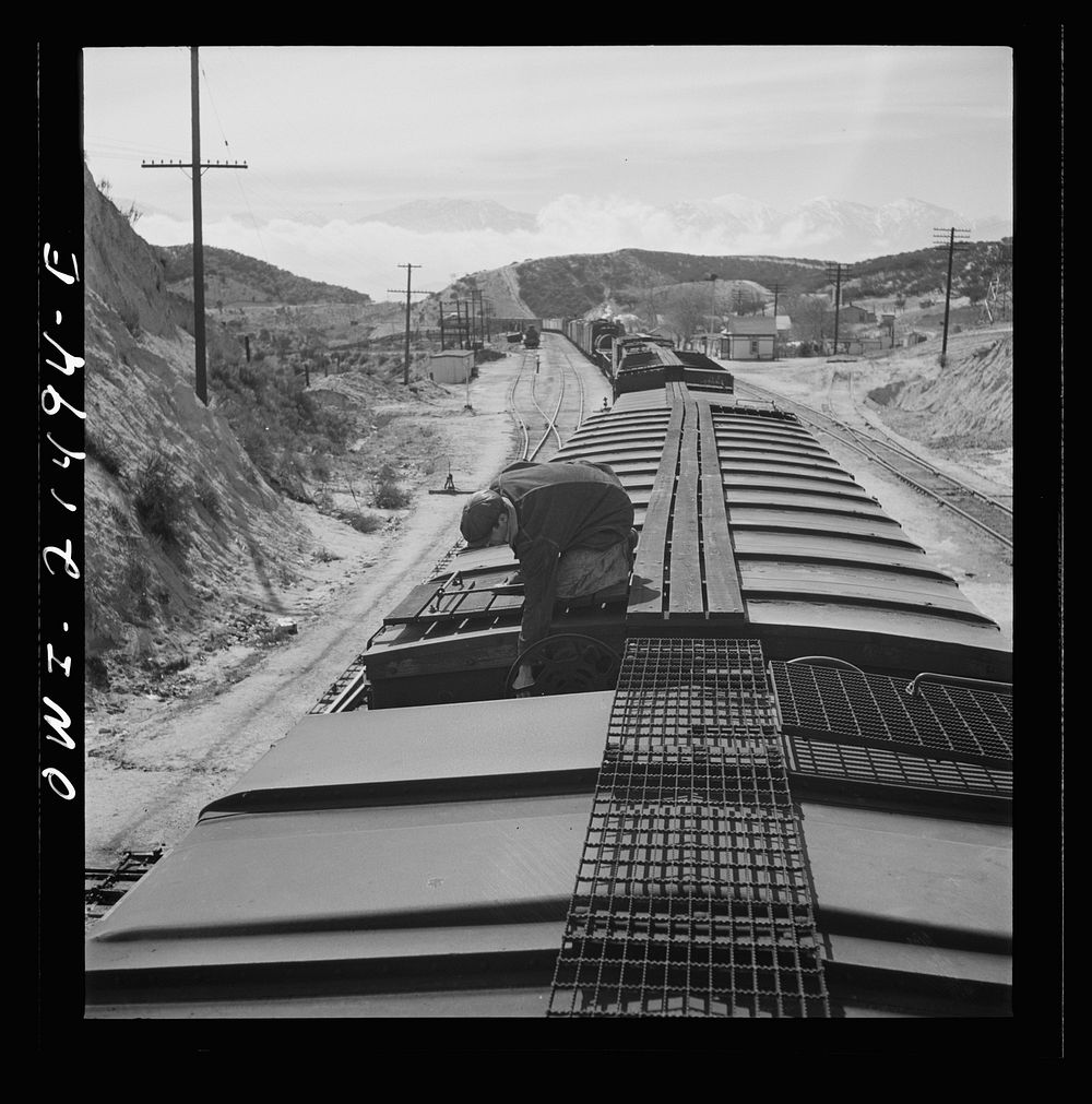 [Untitled photo, possibly related to: Summit, California. The brakeman opening the retainer valve on a car on the Atchison…
