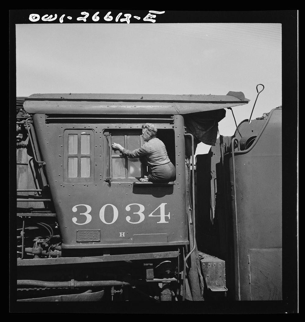 Clinton, Iowa. Women wipers of the Chicago Northwestern cleaning one of the giant freight locomotives. Sourced from the…