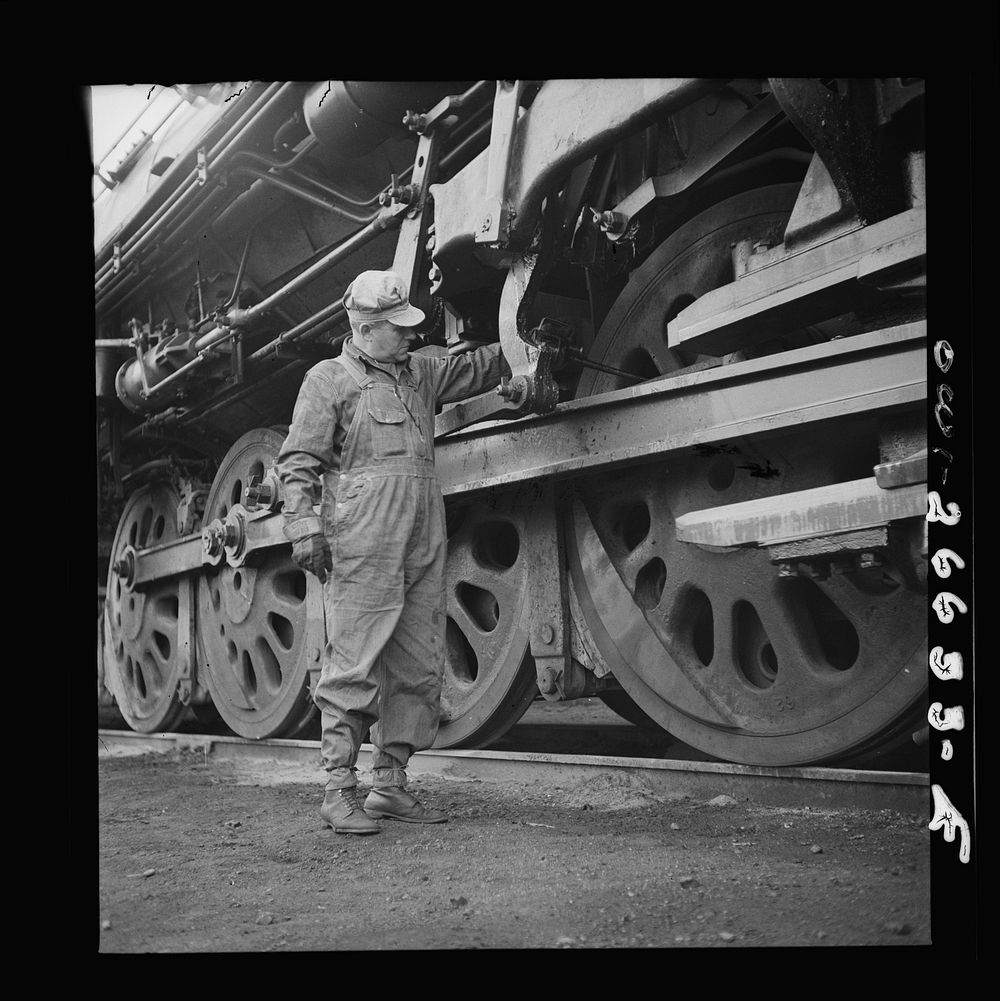 Cicero, Illinois. Engineer of the Chicago, Burlington and Quincy Railroad oiling his engine before going out from the Clyde…