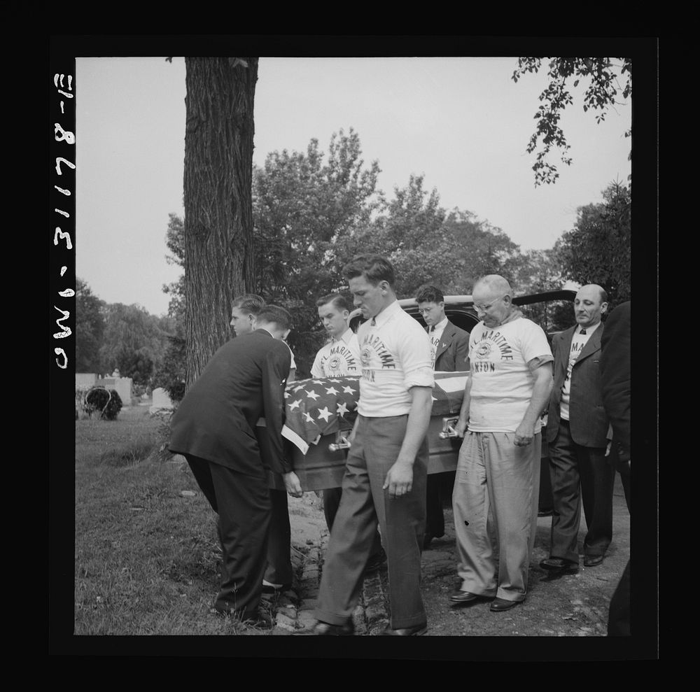 Baltimore, Maryland. Funeral of a merchant seaman. Pallbearers with flag-covered casket. Sourced from the Library of…
