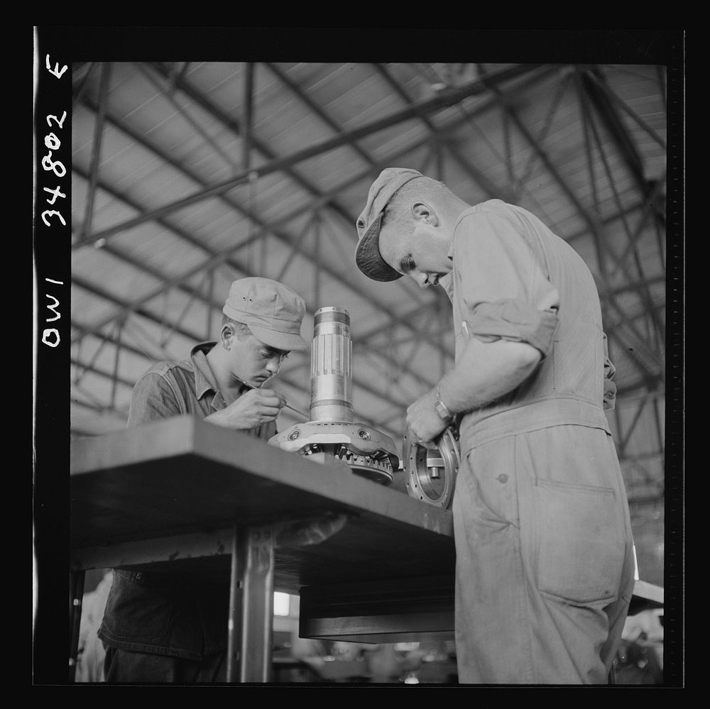 Warner Robins, Georgia. Air Service Command, Robins Field. Assembling the nose section of a Pratt and Whitney engine.…