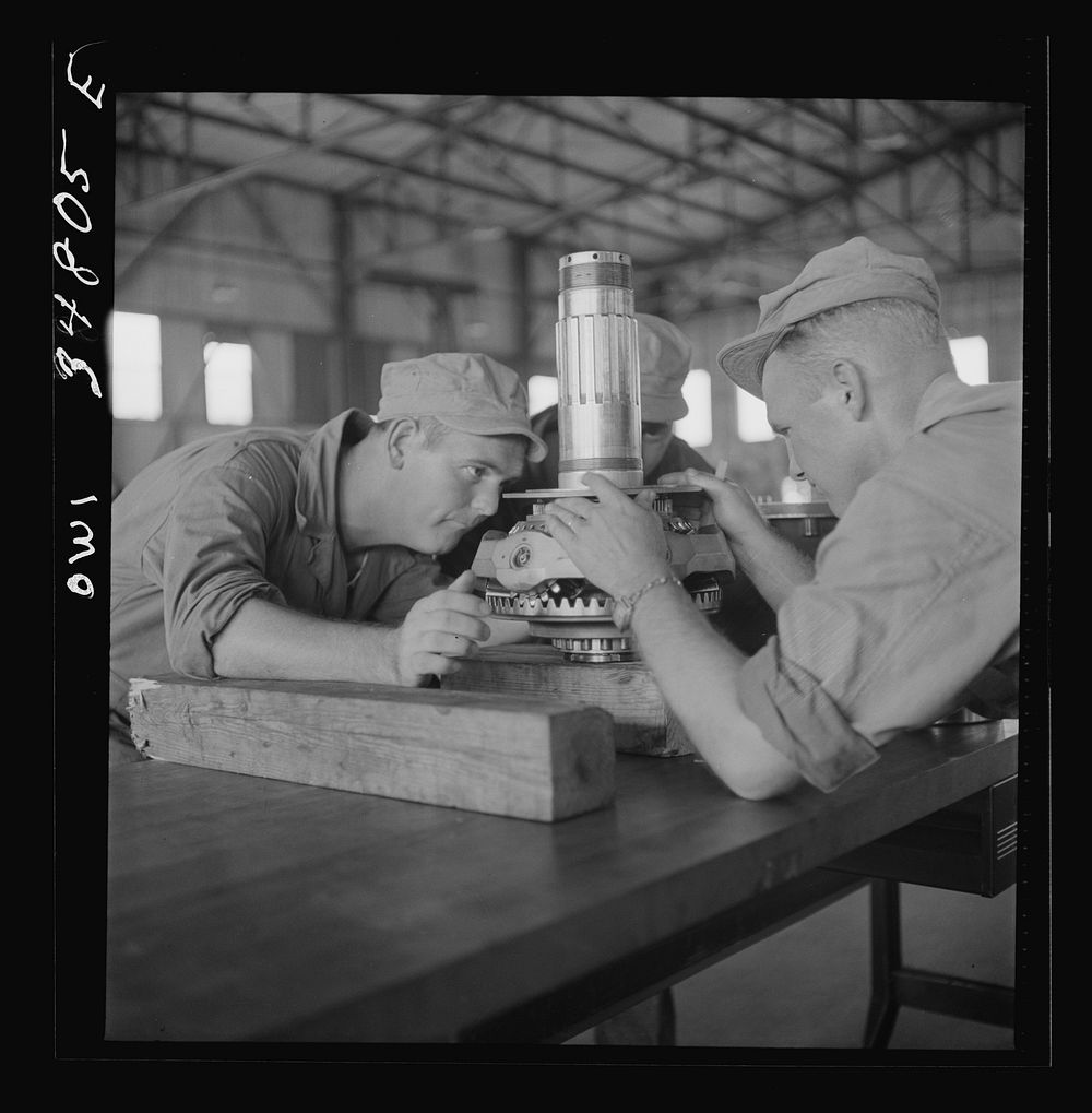 Warner Robins, Georgia. Air Service Command, Robins Field. Assembling the nose of a Pratt and Whitney engine. Sourced from…