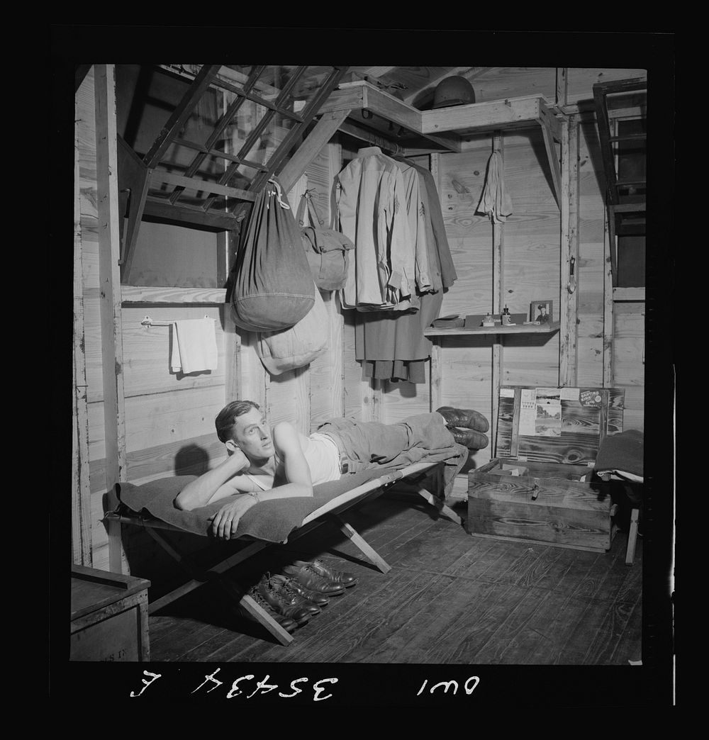 Greenville, South Carolina. Air Service Command. Enlisted man of the 25th service group relaxing in his hutment. Sourced…