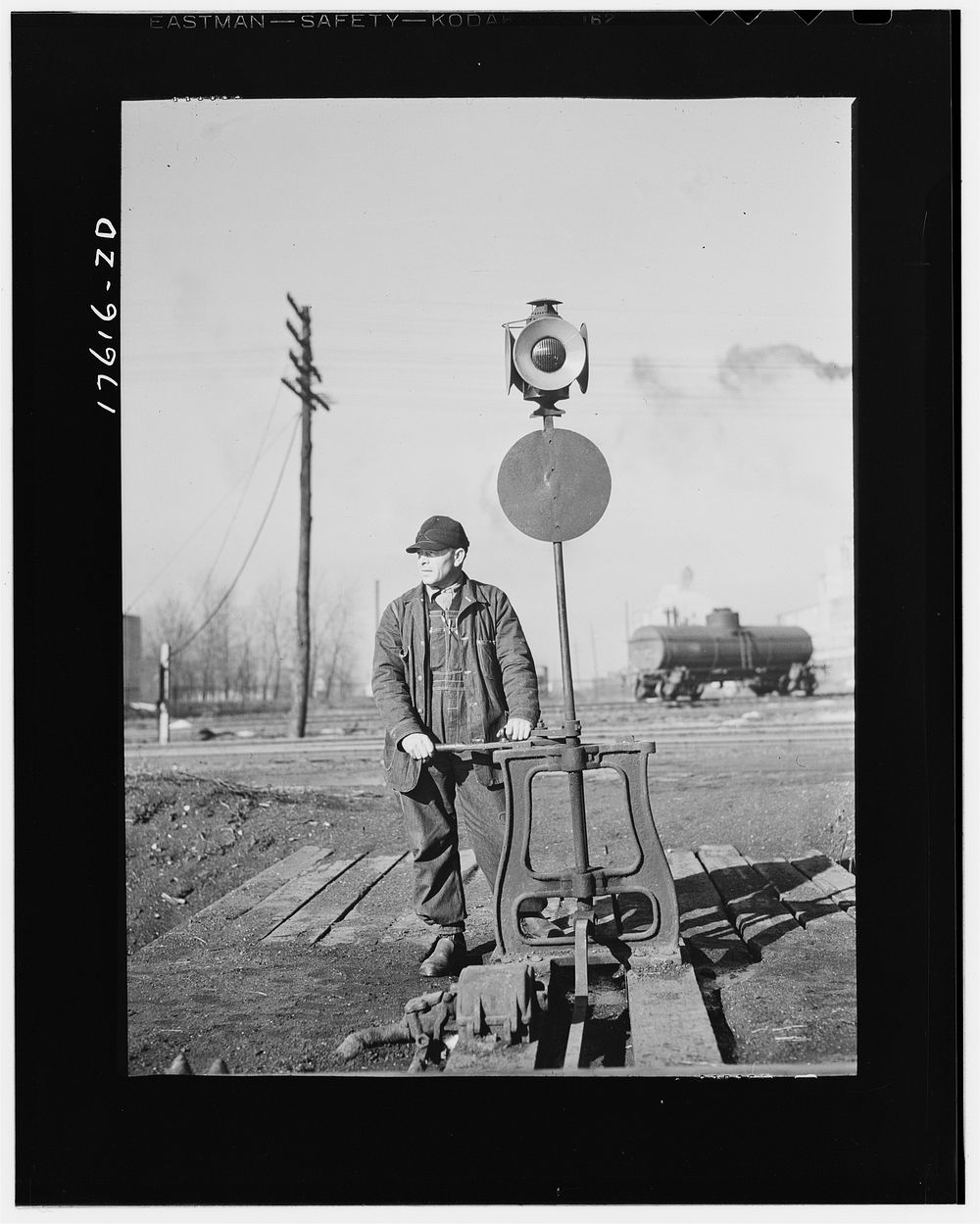 Daniel Senise throwing a switch while at work in an Indiana Harbor Belt line railroad yard. Sourced from the Library of…