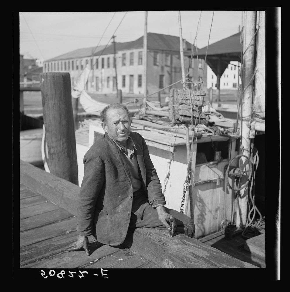 Fisherman on the dock, Charleston, South Carolina, on Christmas Day. He is from Boston and had been repairing motor on boat.…