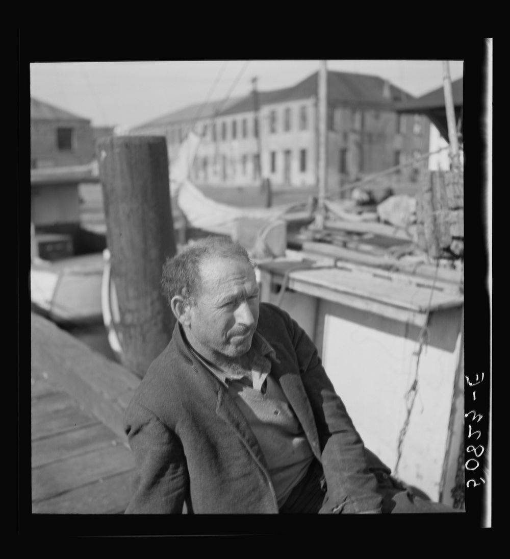 Fisherman on the dock, Charleston, South Carolina, on Christmas Day. He is from Boston and had been repairing motor on boat.…