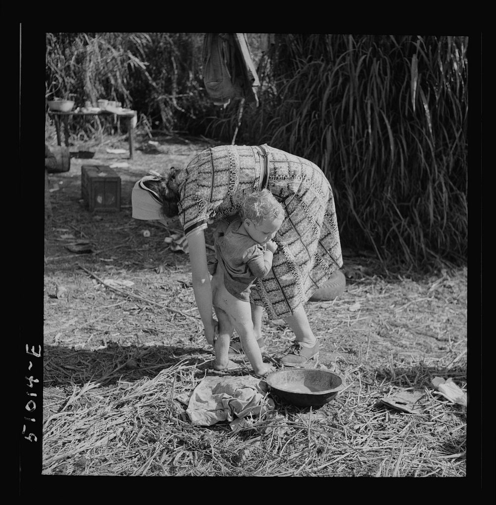 Woman packinghouse worker from Tennessee trying to wash  muck, which causes an itchy rash and sores, off her youngest child.…