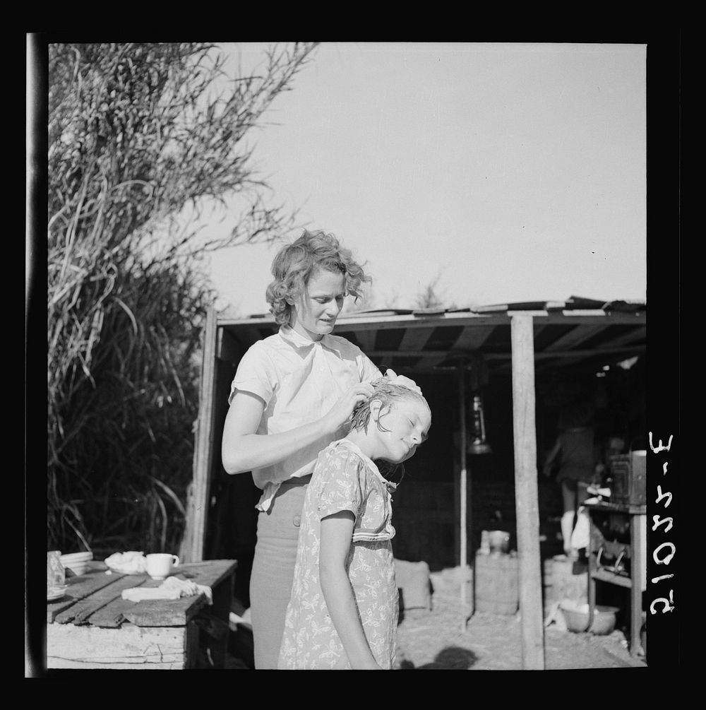 Young woman packinghouse worker from Tennessee, trying to get the  muck, which causes an itchy rash and sores and scabs on…