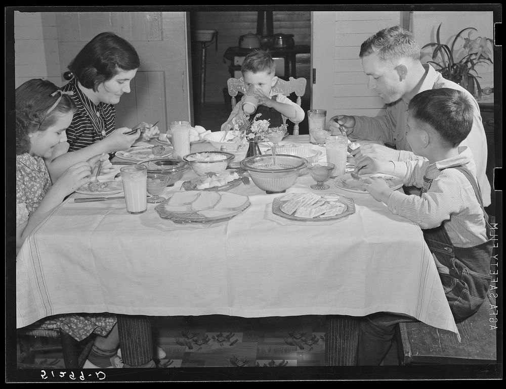 Helms family at dinner which consists of roast beef (home canned), turnip greens, potatoes, biscuits, corn bread, butter…