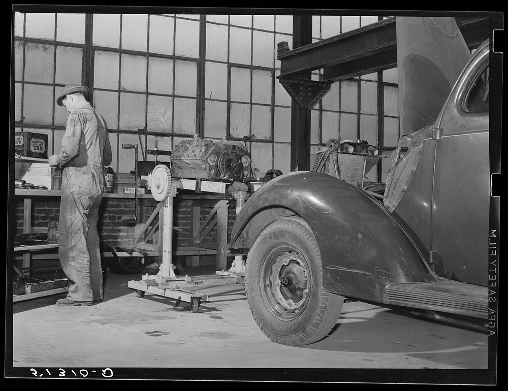 Repairing automobile motor. FSA (Farm Security Administration) warehouse depot. Atlanta, Georgia. Sourced from the Library…