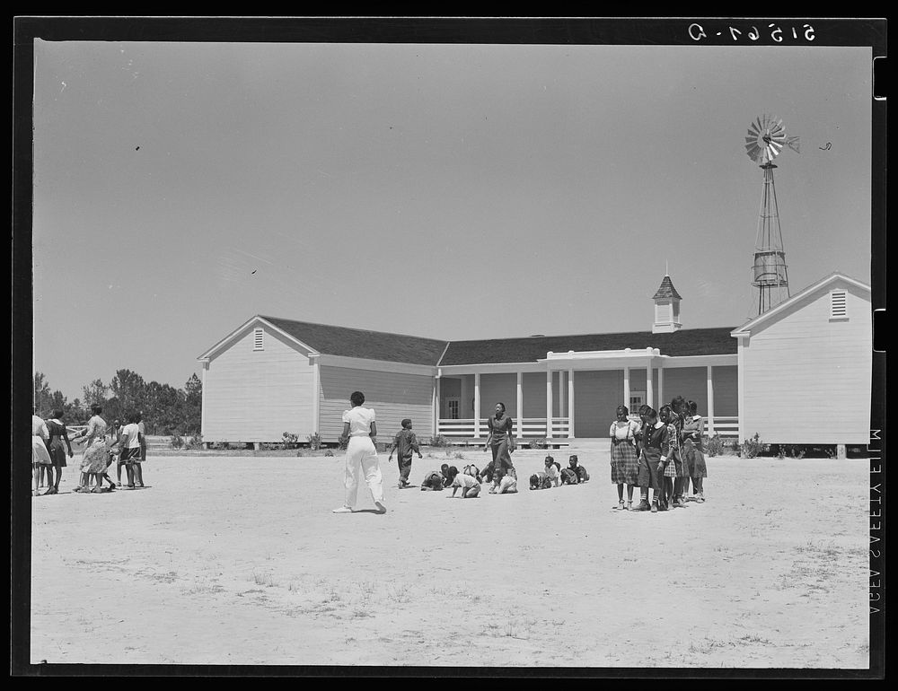 Florence Wright (in white slacks), recreation supervisor, directing games during outdoor period. Gee's Bend, Alabama.…