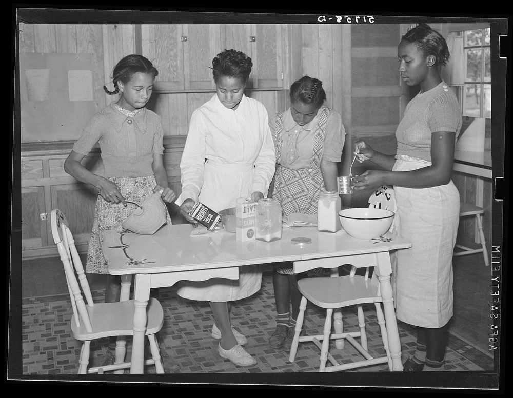 Students with teacher in home economics cooking class. Prairie Farms, Alabama. Sourced from the Library of Congress.