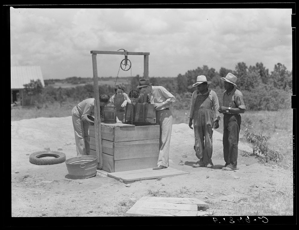 [Untitled photo, possibly related to: FSA (Farm Security Administration) supervisors inspecting new well on client's…