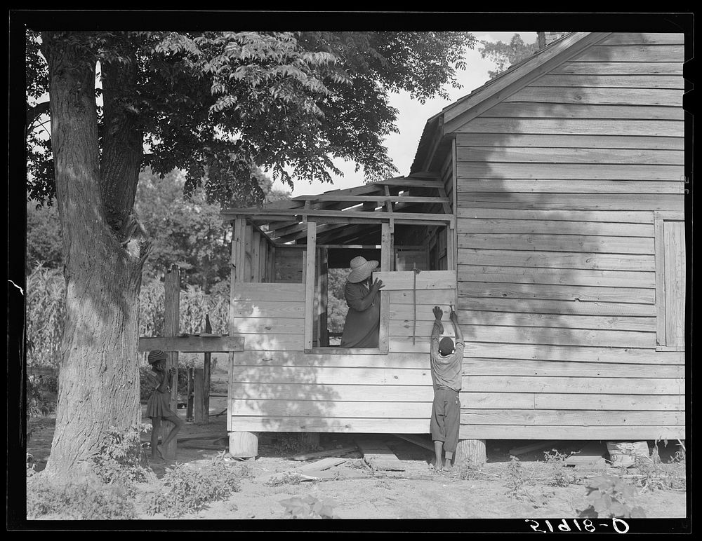 Pauline Clyburn, rehabilitation client, Manning, Clarendon County, South Carolina, and her son repairing home. Sourced from…