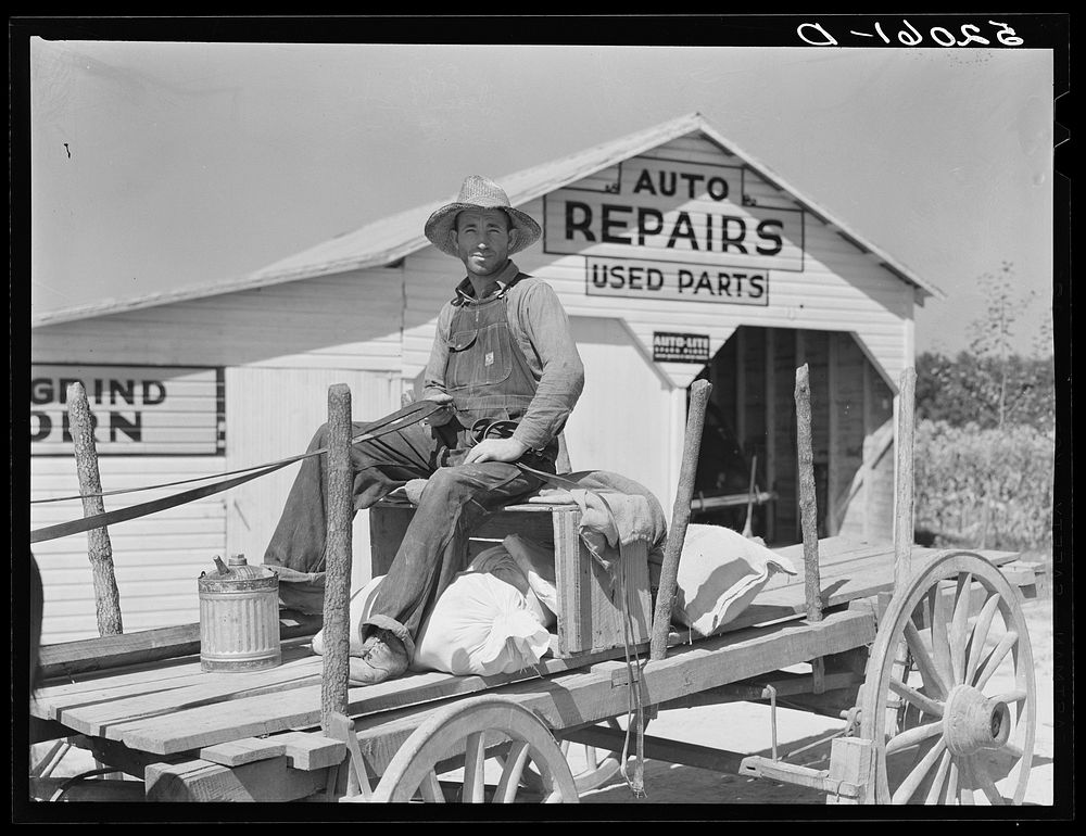 Combination filling station, garage, smith shop, grocery store. Frank Petty, owner of the wagon, has just had his mule shod…