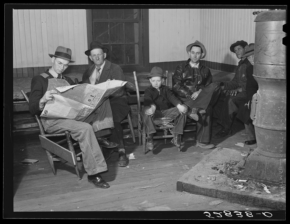 Farmers waiting around in camp room on morning of tobacco auction sale. Mebane, Orange County, North Carolina. Sourced from…