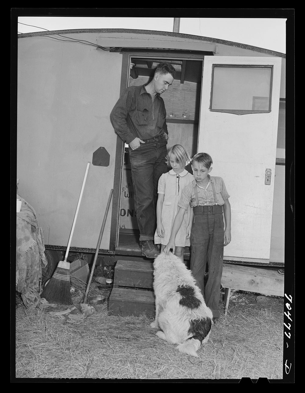 [Untitled photo, possibly related to: Workman at Umatilla ordnance fepot and his children in homemade trailer. Stanfield…