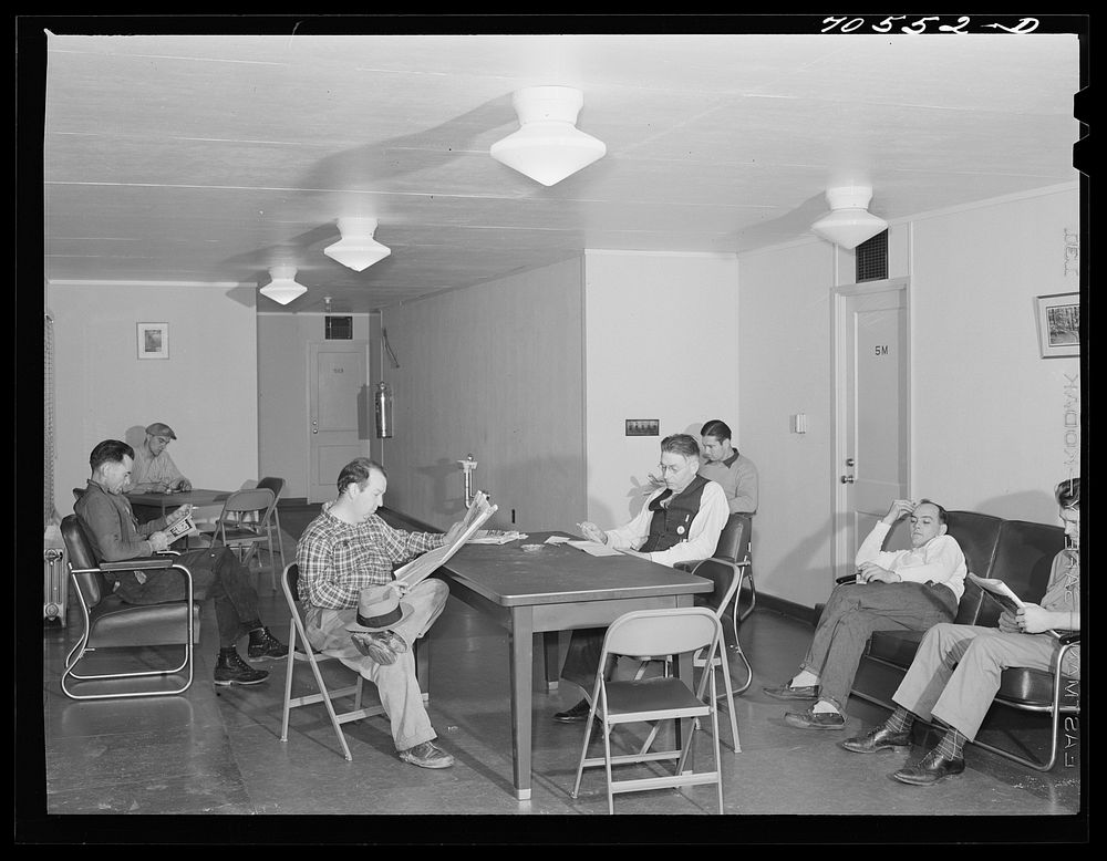 [Untitled photo, possibly related to: Men who work at the Navy shipyards in the community room at the FSA (Farm Security…