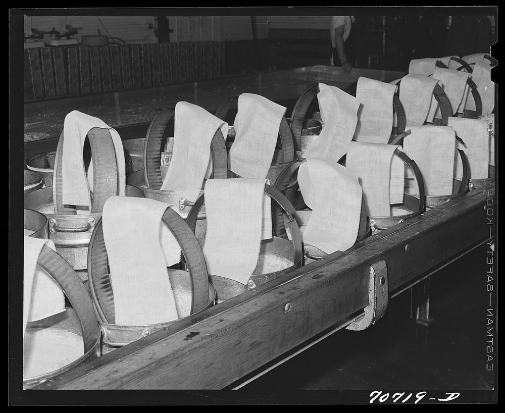 [Untitled photo, possibly related to: Cheesecloth on molds, in which the cheese will be pressed. Tillamook cheese plant…