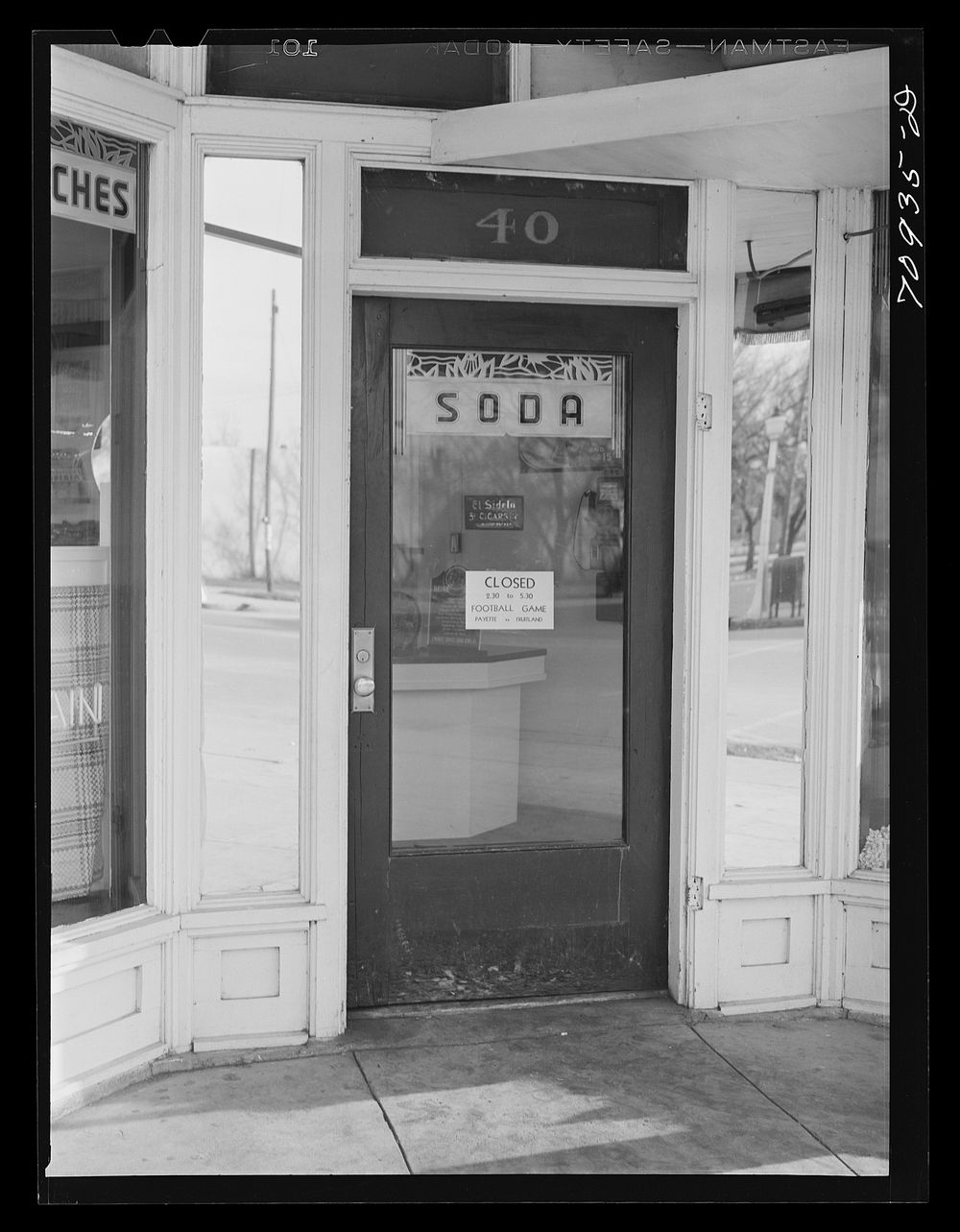 [Untitled photo, possibly related to: Store closed for Thanksgiving Day football game. Payette, Idaho] by Russell Lee