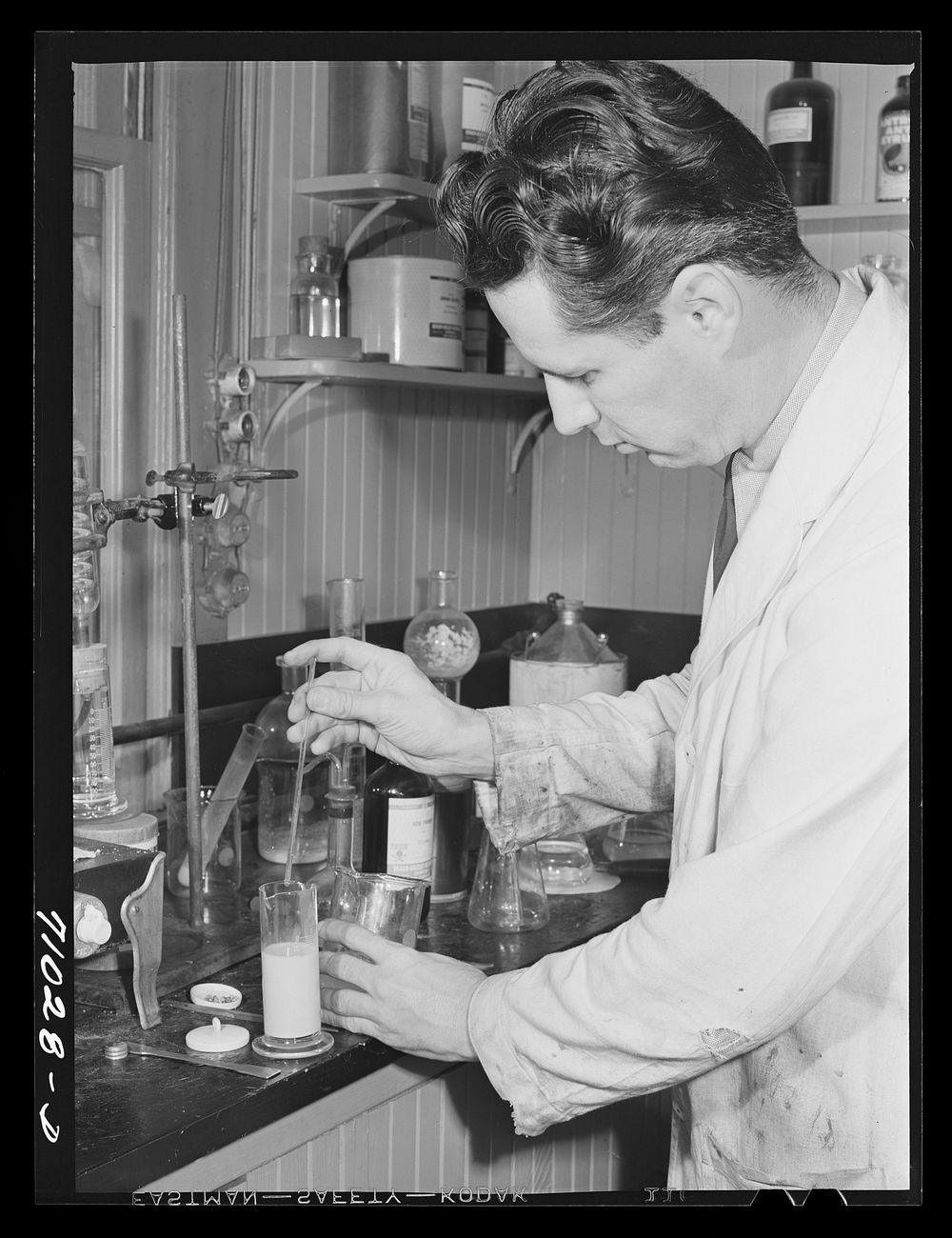 Salinas, California. Intercontinental Rubber Producers. Harry Baucher, head chemist, works on deresinating tests by Russell…