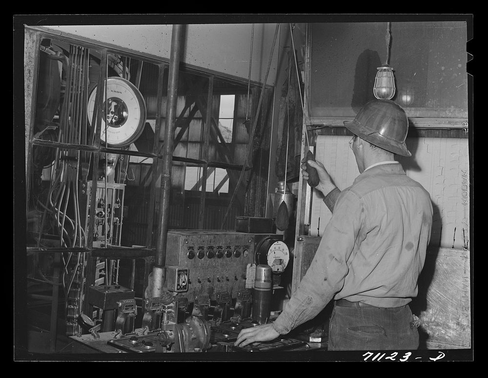 This workman controls amounts of materials going into concrete used in construction of Shasta Dam. Shasta County, California…